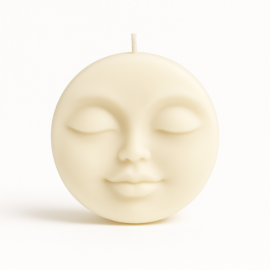 Cream sculptural moon face candle with serene closed eyes – Pretty Moon Candle by THE AURA CO.