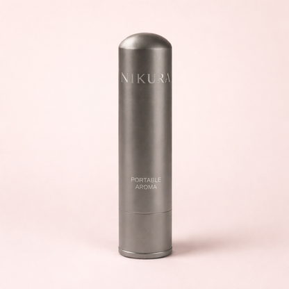 Gunmetal grey portable aromatherapy inhaler on a blush pink background – THE AURA CO.