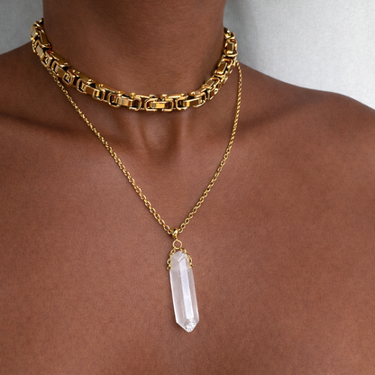 Clear quartz crystal point pendant on a delicate gold chain worn layered with a chunky gold Byzantine choker – Angel Aura Pendant by THE AURA CO.