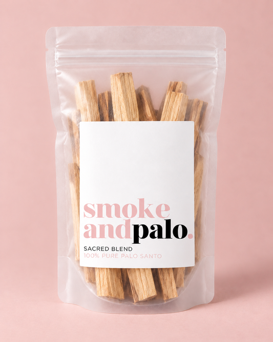 SMOKE & PALO SACRED BLEND palo santo wood sticks in a clear resealable pouch against a blush-pink background.